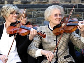 Well-known Canadian fiddler Kelli Trottier, left, plays fiddle with Sen. Elizabeth Hubley at a reception on Parliament Hill on Wednesday in celebration of Canada's first National Fiddling Day.