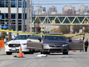 Police investigate a homicide on Tremblay Road at Belfast Road, May 3, 2015.