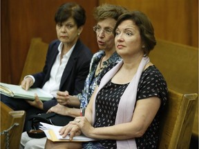 Roxanne Dube, right, Canadian Consul General to Miami and mother of Marc Wabafiyebazu, sits in court during his bail hearing at the Richard E. Gerstein Justice Building in Miami, Wednesday, Ma7 27, 2015. Wabafiyebazu, 15, is charged with murder and other crimes in the March 30 drug-related South Florida shootout that killed his older brother and another youth. He is seeking release from custody on bail.