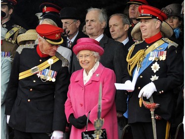 Britain's Queen Elizabeth II wears pink during a visit to Richmond Castle, northern England, with Prince Andrew Duke of York, right, to attend the military amalgamation parade of The Queen's Royal Lancers and 9th/12th Royal Lancers, Saturday May 2, 2015.  Kate, the Duchess of Cambridge, has given birth to a baby girl, royal officials announced earlier Saturday. (John Giles / PA VIA AP) UNITED KINGDOM OUT - NO SALES - NO ARCHIVES