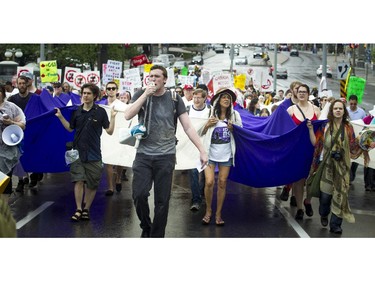 Sam Heaton (with the megaphone) leads the crowd along Elgin Street, protesting the government's proposed anti-terrorism legislation, Bill C-51, Saturday, May 30, 2015.