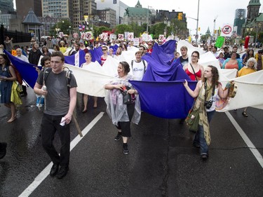 Sam Heaton (with the megaphone) leads the crowd along Rideau Street, protesting the government's proposed anti-terrorism legislation, Bill C-51, Saturday, May 30, 2015.