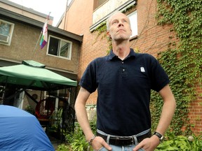 Sean Walker in his backyard, which is overlooked by his neighbours' balcony.