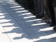 Shadows from veterans are seen on the ground prior to the start of a ceremony honouring the National Battle of the Atlantic took place at the National War Memorial in Ottawa, May 3, 2015.