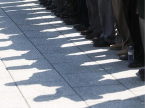 Shadows from veterans are scene on the ground prior to the start of a ceremony honouring the National Battle of the Atlantic took place at the National War Memorial in Ottawa, May 3, 2015.