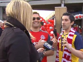 Shauna Hunt interviews a two Toronto FC soccer fans in Toronto on Sunday, May 10, 2015, in this video frame grab. A Toronto reporter is setting social media abuzz by fighting back against a controversial trend that sees men hurling obscenities at female journalists on the job.