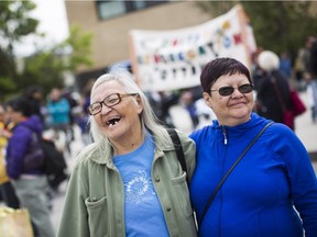 Residential school survivors Grace Aisaican (left) and Maryann Napope (right) share a laugh before the start of the reconciliation march.