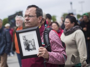 The Truth and Reconciliation march took place in Gatineau making its was into Ottawa, May 31, 2015. John Moses hold a photo of his father Russ and aunt Thelma taken at the Mohawk Institute in 1943.