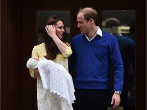 Britain's Prince William, Duke of Cambridge, looks towards his wife Catherine, Duchess of Cambridge as they show their newly-born daughter, their second child, to the media outside the Lindo Wing at St Mary's Hospital in central London, on May 2, 2015.  The Duchess of Cambridge was safely delivered of a daughter weighing 8lbs 3oz, Kensington Palace announced. The newly-born Princess of Cambridge is fourth in line to the British throne.