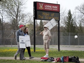 Peel Region teachers walk the picket line at Mississauga's Lorne Park High School as the teachers strike continues, Tuesday May 5, 2015.