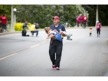 Trinity O'Meara Knapp gets a little help towards the end of the 2K race at Tamarack Ottawa Race Weekend Saturday May 23, 2015.