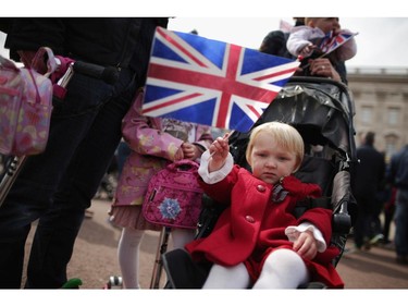 LONDON, UNITED KINGDOM - MAY 02:  Two-year-old Fleur Burrows waves the Union Jack flag, joining thousands of people in front of Buckingham Palace after the announcement of the birth of Prince William, Duke of Cambridge and the Duchess of Cambridge's second child outside Buckingham Palace May 2, 2015 in London, United Kingdom. Catherine, Duchess of Cambridge delivered the baby girl at 8:34am Saturday and she is the fourth in line to the throne and the Queen's fifth great-grandchild.