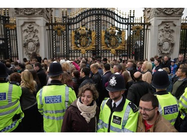 LONDON, UNITED KINGDOM - MAY 02:  Thousands of people line up for a chance to glimpse and photograph the announcement of the birth of Prince William, Duke of Cambridge and the Duchess of Cambridge's second child outside Buckingham Palace on May 2, 2015 in London, United Kingdom. The baby girl arrived at 8:34am Saturday and is the fourth in line to the throne and the Queen's fifth great-grandchild.