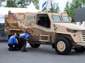 Visitors get a close up look at an armoured vehicle at last year's CANSEC military fair in Ottawa.