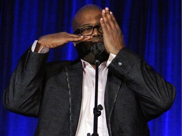 Visually impaired comic Darryl Lenox gives the audience an idea of how poor his eyesight is while performing on Wednesday, May 20, 2015, at a cabaret fundraising show for Reach Canada,  a non-profit lawyer referral organization that helps people with disabilities.