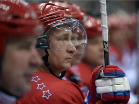 Russian President Vladimir Putin watches an exhibition hockey game at a tournament of the Night Hockey League in the Black Sea resort of Sochi, Russia, Saturday, May 16, 2015. President Vladimir Putin has played in an exhibition hockey game and scored one goal after another on assists from retired NHL players. (Alexei Nikolsky/RIA-Novosti, Kremlin Pool Photo via AP)