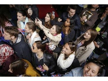 Well wishers gather and take photos as Britain's Prince William leaves St. Mary's Hospital's exclusive Lindo Wing, London, Saturday, May 2, 2015. William's wife, Kate, the Duchess of Cambridge, gave birth to a baby girl on Saturday morning.