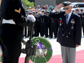 Second World War veteran John McLean salutes after laying a wreath.
