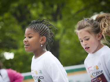 Young girls push to finish the kids marathon at Tamarack Ottawa Race Weekend, Sunday, May 24, 2015.