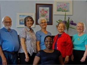 Choir director Roxanne Goodman, seated, with dome member of the Sunset Singers. The choir performs at Centrepointe on June 20.