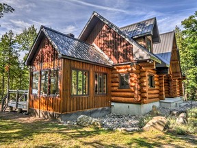 The picturesque home sits in perfect harmony with its surroundings and features soaring ceilings and open peaks that fill the serene space with light.