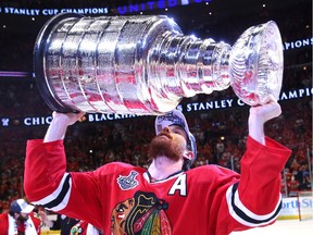 Duncan Keith of the Chicago Blackhawks hoists the Stanley Cup.
