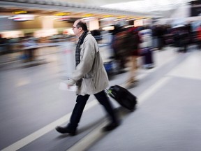 A man carries his luggage at Pearson International Airport in Toronto on December 20, 2013.