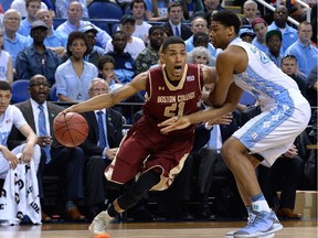 Olivier Hanlan #21 of the Boston College Eagles drives on  Isaiah Hicks #22 of the North Carolina Tar Heels during a second round game of the ACC basketball tournament at Greensboro Coliseum on March 11, 2015 in Greensboro, North Carolina.