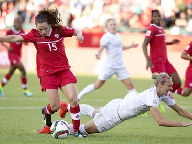 Canada's Allysha Chapman (15) trips up New Zealand's Hannah Wilkinson (17) during FIFA World Cup during first half action in Edmonton, Alta., on Thursday June 11, 2015.