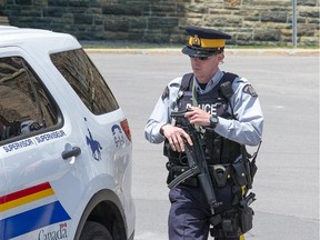 An RCMP officer carries an automatic weapon while patrolling on Parliament Hill this week.