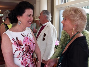 Arriving guest Vicki Heyman, wife of the U.S. ambassador, is greeted by Carole Whittall at the annual garden party and fashion show for Cornerstone Housing for Women, held Sunday, June 7, 2015, at the official residence of the Irish ambassador.
