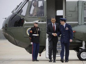 President Barack Obama walks from Marine One with Force Col. Greg N. Urtso, Sunday, May 5, 2013, in Andrews Air Force Base, Md.