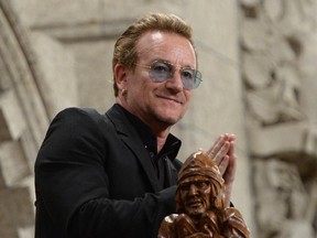 U2 frontman Bono is recognized in the visitors' gallery in the House of Commons in Ottawa on Monday, June 15, 2015. Bono was in Ottawa for a meeting with political leaders and non-profit organizations.