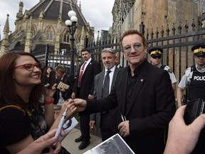 U2 frontman Bono leaves Parliament Hill in Ottawa on Monday, June 15, 2015. Bono is in Ottawa for a meeting with political leaders including Prime Minister Stephen Harper and non-profit organizations