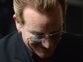 U2 frontman Bono leaves the National Arts Centre in Ottawa on Monday, June 15, 2015. Bono is in Ottawa for a meeting with political leaders and non-profit organizations.