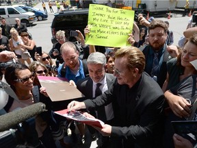 U2 frontman Bono signs autographs in Ottawa on Monday, June 15, 2015. The Irish rocker was in Ottawa for a meeting with political leaders and non-profit organizations.