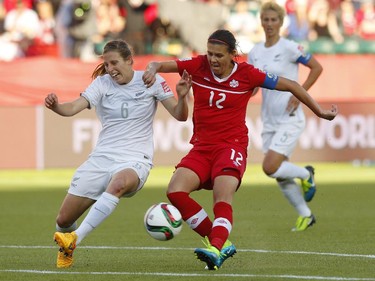 Christine Sinclair #12 of Canada and Rebekah Stott #6 of New Zealand battle for the ball during the FIFA Women's World Cup Canada Group A match between Canada and New Zealand at Commonwealth Stadium on June 11, 2015 in Edmonton, Alberta, Canada.