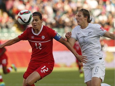 EDMONTON, AB - JUNE 11: Christine Sinclair #12 of Canada keeps the ball from Rebekah Stott #6 of New Zealand during the FIFA Women's World Cup Canada Group A match between Canada and New Zealand at Commonwealth Stadium on June 11, 2015 in Edmonton, Alberta, Canada.