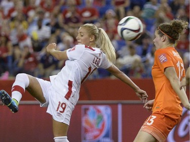 Canada's Adriana Leon (19) and Netherlands' Dominique Janssen (13) battle for the ball during second half FIFA Women's World Cup soccer in Montreal on Monday, June 15, 2015.