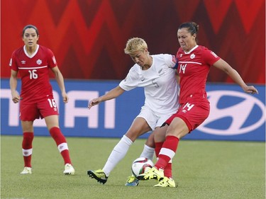 Canada's Melissa Tancredi and New Zealand's Abby Erceg battle during second half FIFA Women's World Cup soccer action in Edmonton, Alta., Thursday, June11, 2015.