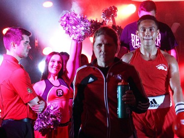 Cedric Parina from Ottawa's Beaver Boxing Club makes his way to the ring, led by coach Jill Perry, at Ringside for Youth XXI, held at the Shaw Centre on Thursday, June 11, 2015.