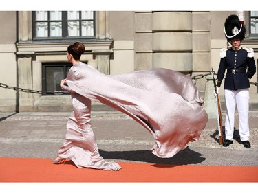 The train of a guest's dress blows in the wind arriving to the royal wedding of Prince Carl Philip of Sweden and Sofia Hellqvist at The Royal Palace on June 13, 2015 in Stockholm, Sweden.