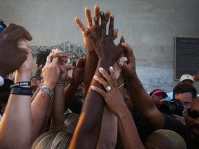 People hold hands as they join together on the Arthur Ravenel jr. bridge to commemorate the lives lost in the shooting at the Emanuel African Methodist Episcopal Church on June 21, 2015 in Charleston, South Carolina.