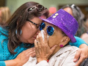 Corrine Potts hugs her stepmother Marceline Potts, 86, an Indian Residential School survivor, during the presentation of the report of the Truth and Reconciliation Commission at the Delta Hotel on Tuesday morning.