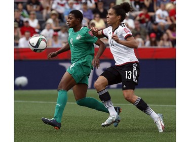 Cote d'Ivoire's Nina Kpaho (4) defends Celia Sasic (13) of Germany during the first half of their first match of the FIFA Women's World Cup at TD Place in Ottawa Saturday June 07, 2014.