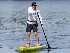 Councillor David Chernushenko paddles a standup paddle board up the Rideau Canal to City Hall from Dow's Lake in honour of Canadian Environment Week and "Stand Up for CHEO"