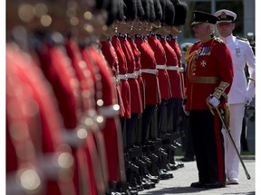 Governor General David Johnston stops to speak with a soldier as he inspects the Ceremonial Guard at Rideau Hall Monday June 23, 2014 in Ottawa.