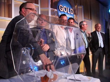 Dean Karakasis pulls out the number of the next ticket during the exciting elimination draw held during the 30th Annual Gold Plate Dinner at the Hellenic Meeeting and Reception Centre on Tuesday, June 9, 2015.