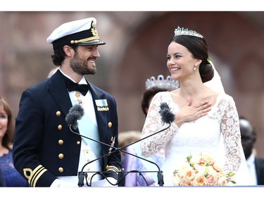 Prince Carl Philip of Sweden and his wife Princess Sofia of Sweden salute the crowd after their marriage ceremony on June 13, 2015 in Stockholm, Sweden.