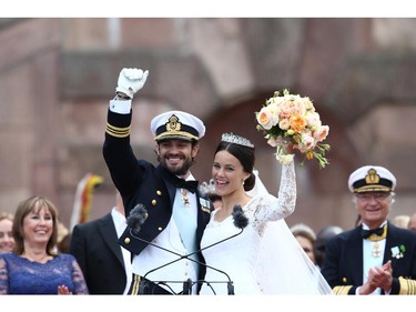 Prince Carl Philip of Sweden and his wife Princess Sofia of Sweden salute the crowd after their marriage ceremony on June 13, 2015 in Stockholm, Sweden.